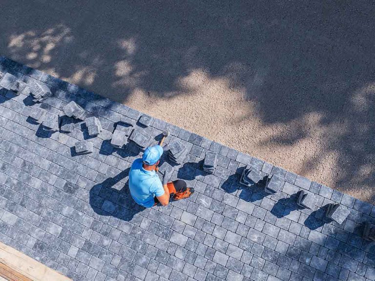skilled-worker-laying-pavers-in-a-sunny-outdoor-sp-2025-03-16-19-38-54-utc